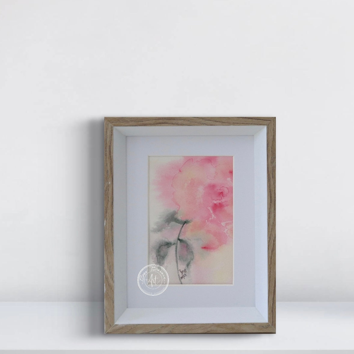 Framed artwork of a pink flower on a white background