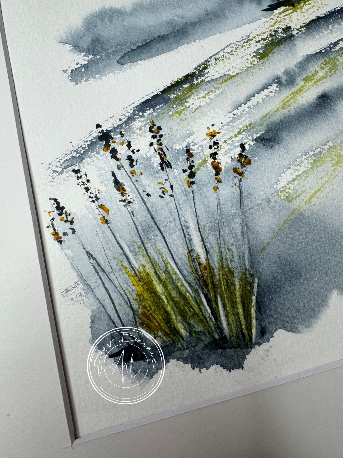 Watercolor painting of grass and sky with a signature in the corner
