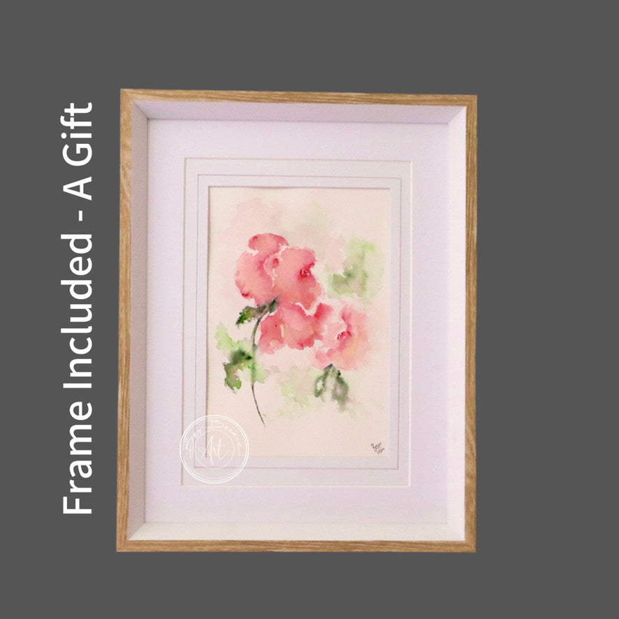 Watercolour painting of three pink roses with green leaves against a soft, blended background, framed in a light wood frame with a white mat.
