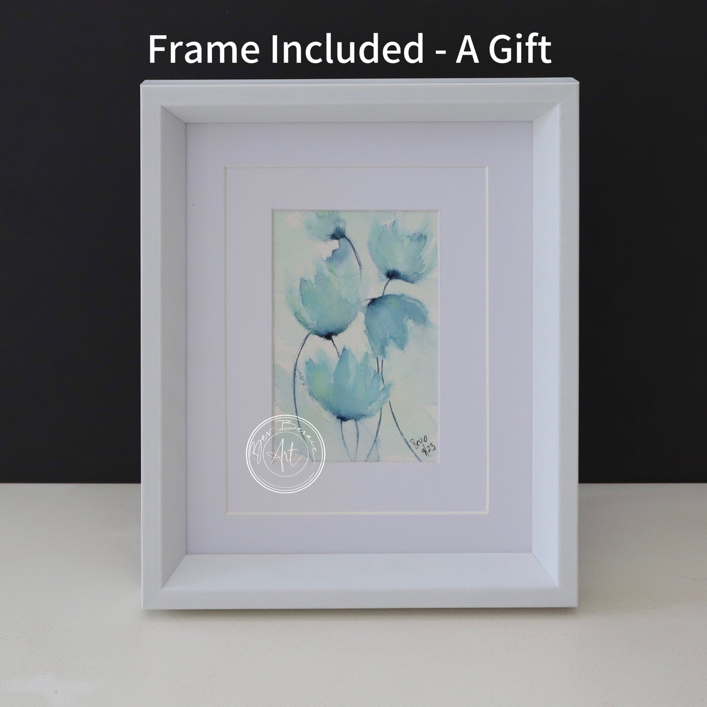 Watercolour painting of stylised, translucent blue flowers with hints of green on a textured, off-white background, framed in a white frame with a white mat.