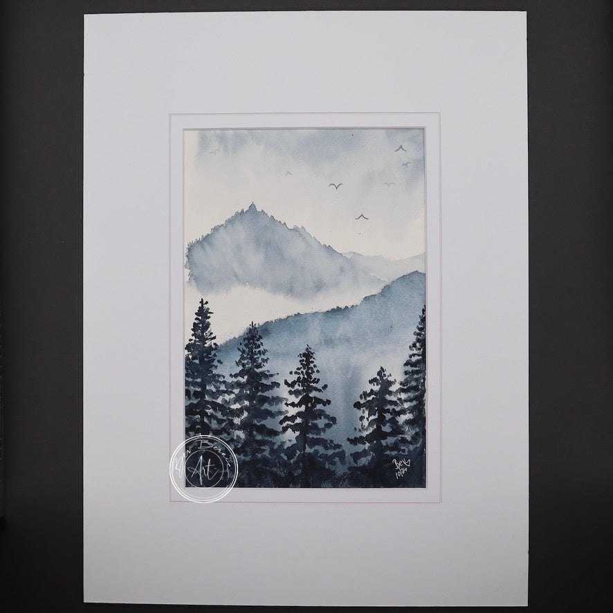 Watercolour painting of a misty mountain landscape with dark evergreen trees in the foreground and hazy blue mountains in the background.