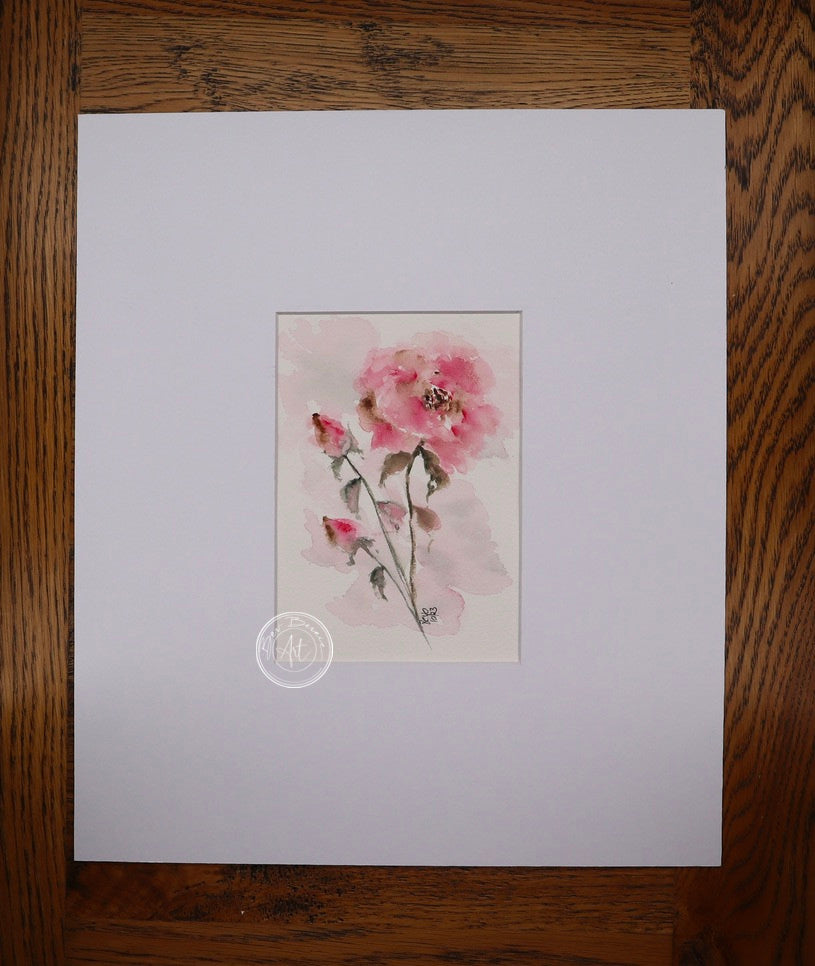 Watercolour painting of a single pink rose with two closed buds on a slender stem, set against a soft, hazy pink background.