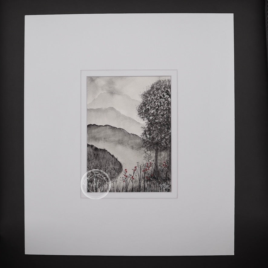A black and white landscape painting with a single tree in the foreground and misty mountains in the background. Small red flowers add a touch of colour at the base of the tree.