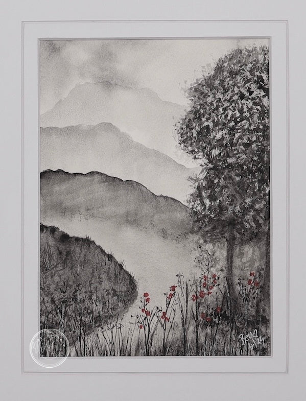 A black and white landscape painting with a single tree in the foreground and misty mountains in the background. Small red flowers add a touch of colour at the base of the tree.