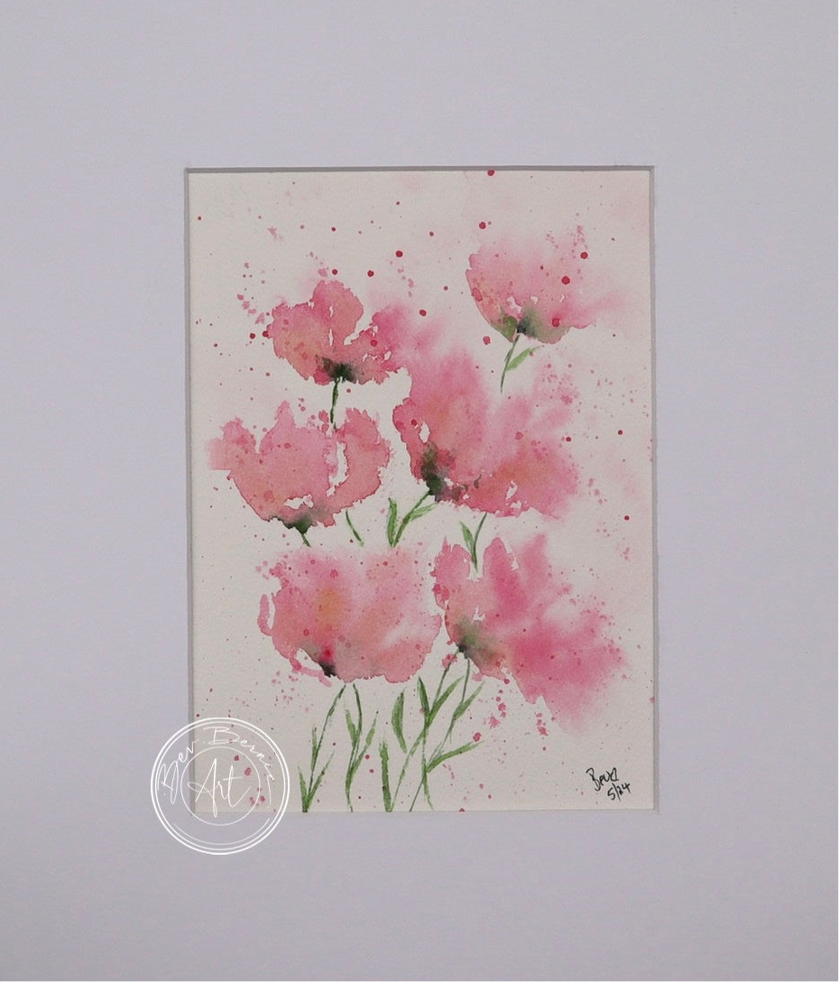 Watercolour painting of five pink poppies with delicate green stems, splattered with pink paint on a white background.
