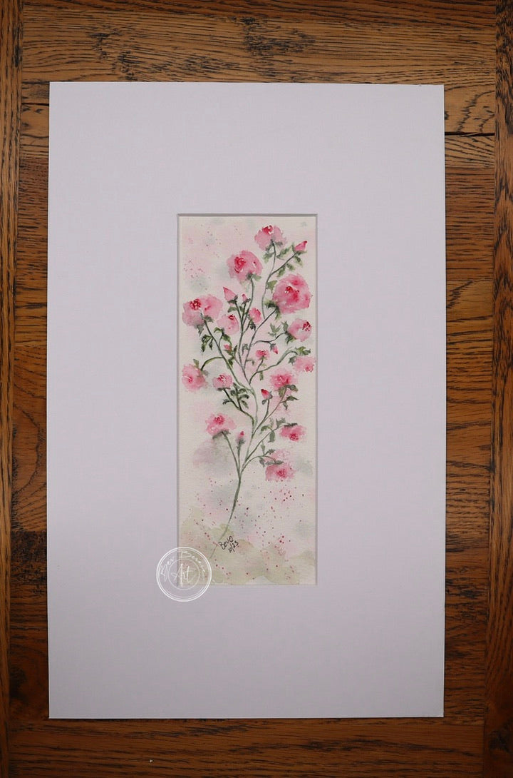 Watercolour painting of a delicate stem with multiple small pink blossoms and green leaves, set against a soft pink and white background with subtle splatters.