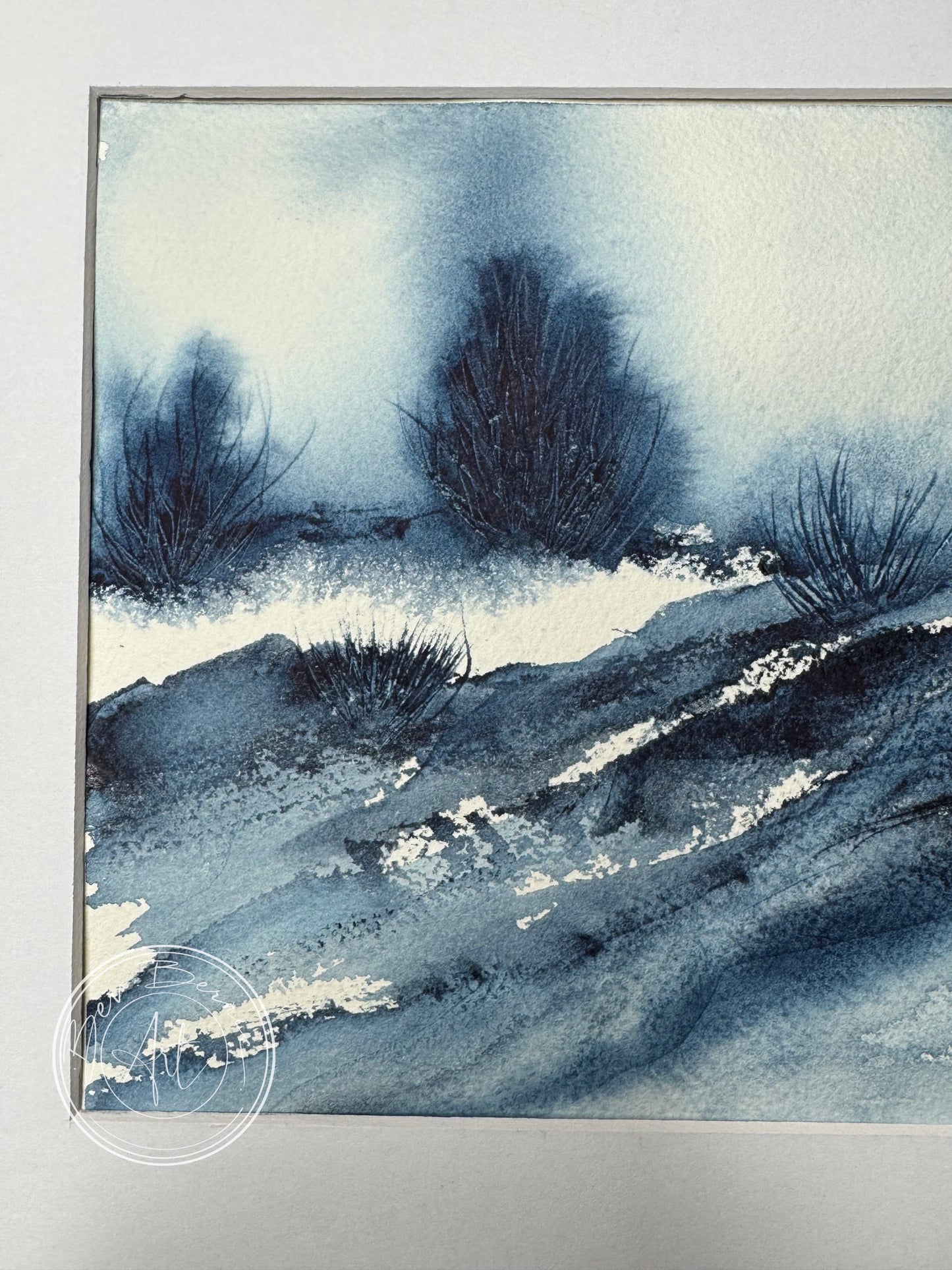 zoomed in image of a blue landscape painting with bushes 