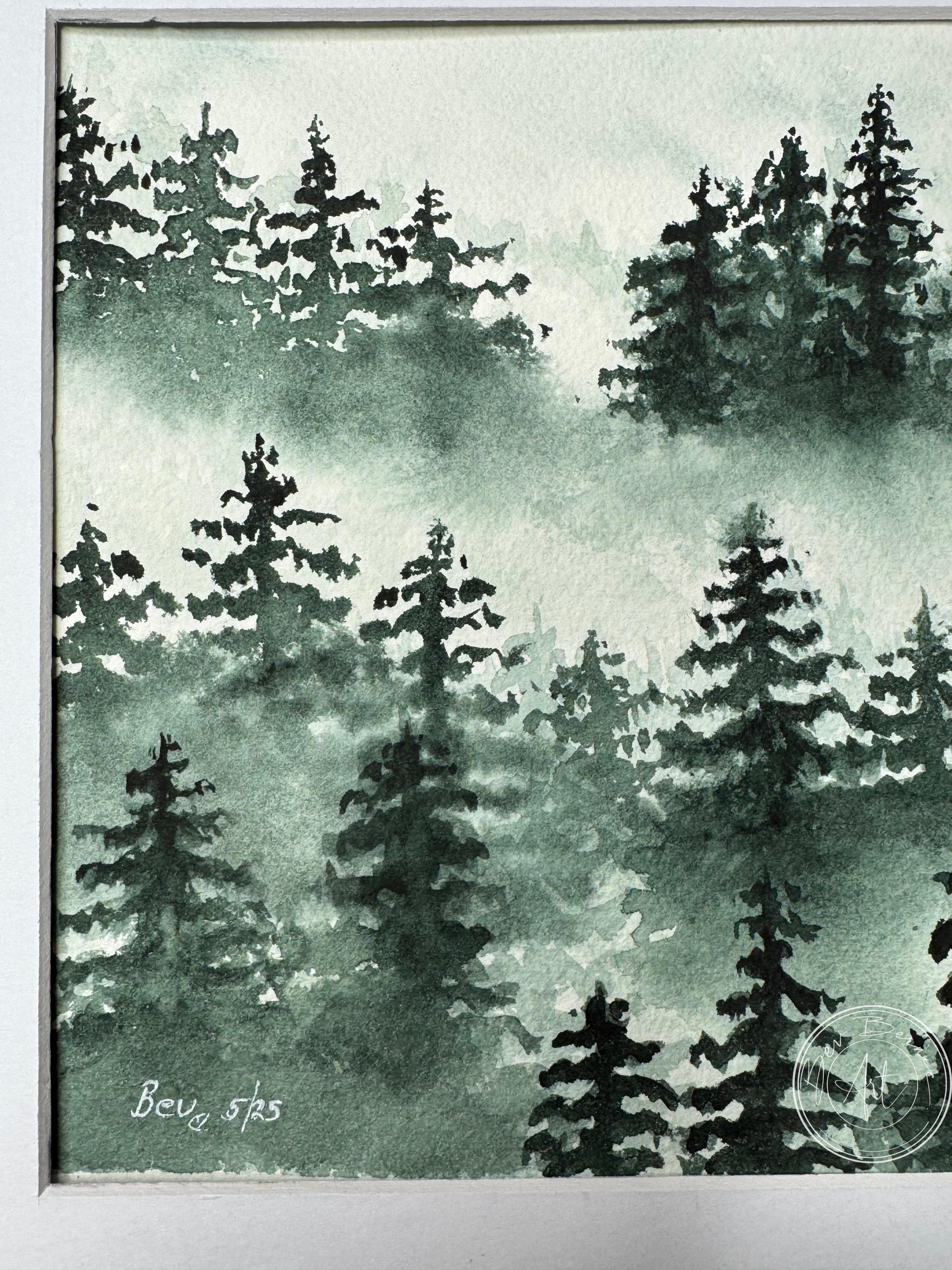 Framed artwork of a forest scene with trees in green tones.