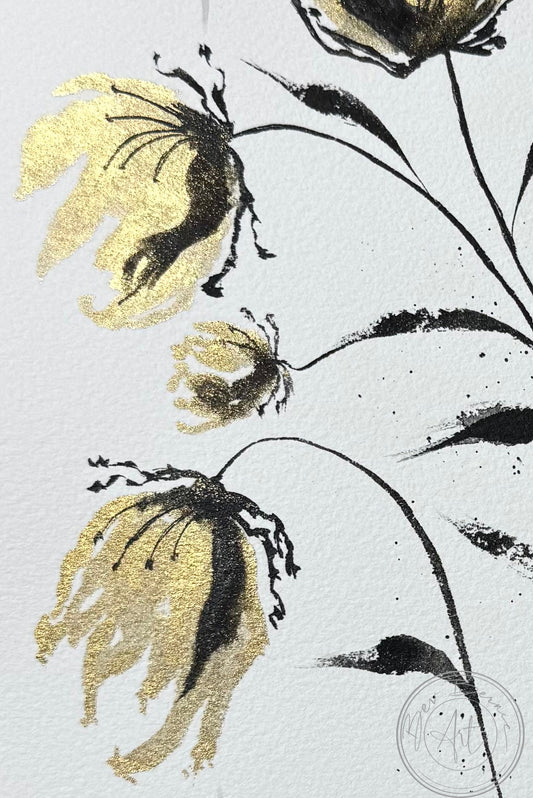 Decorative fabric with gold and black floral patterns on a light gray background