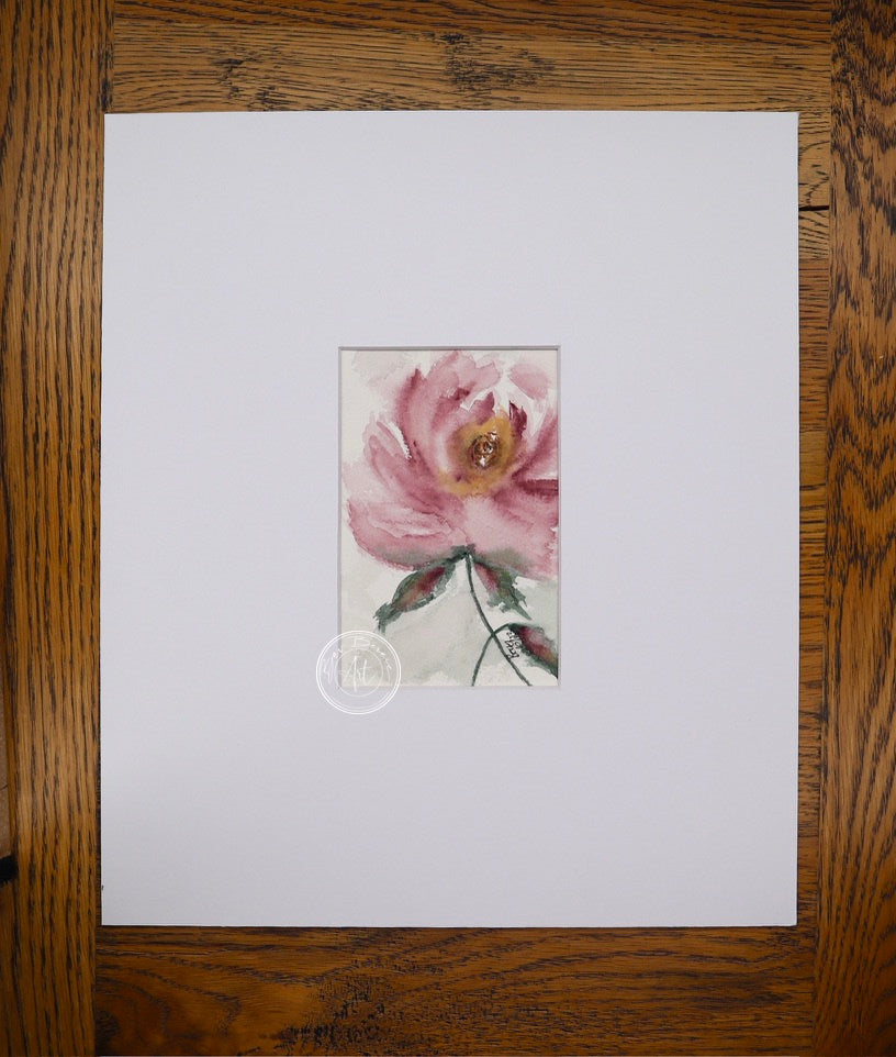 Watercolour painting of a single pink flower with a golden centre, green leaves, and a delicate stem against a light grey background.