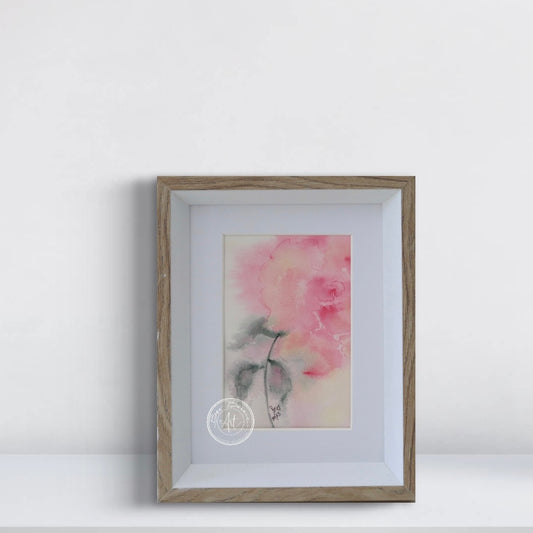 Framed artwork of a pink flower on a white background